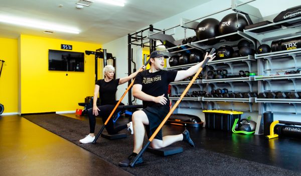 corrective exercise being demonstrated by trainer from pure function woodland hills